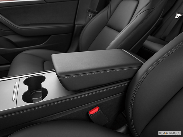 2023 Tesla Model 3 | Front center console with closed lid, from driver’s side looking down
