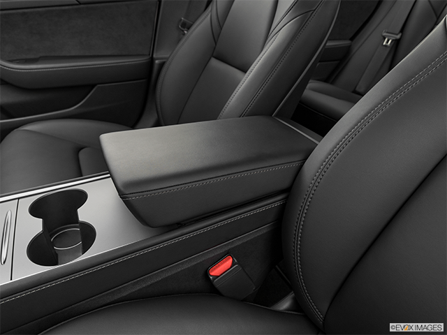 2023 Tesla Model 3 | Front center console with closed lid, from driver’s side looking down