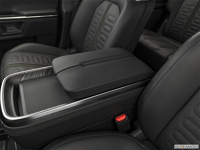 2023 Rivian R1S | Front center console with closed lid, from driver’s side looking down