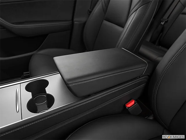 2026 Tesla Model Y | Front center console with closed lid, from driver’s side looking down